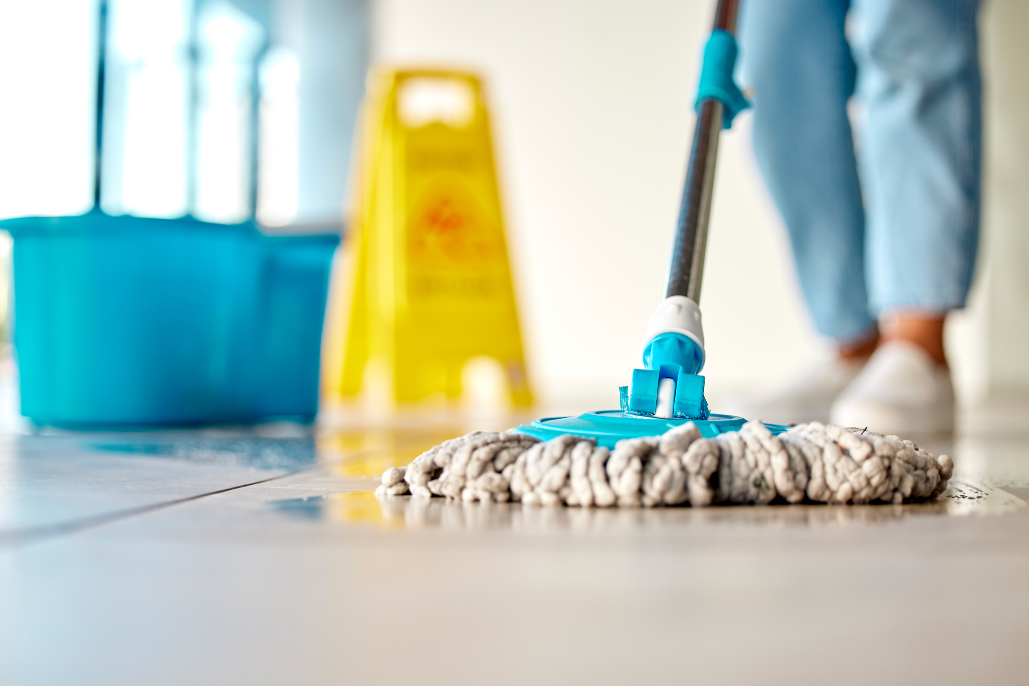 Mop cleaning hospital floor. Demonstrating healthcare disinfection.