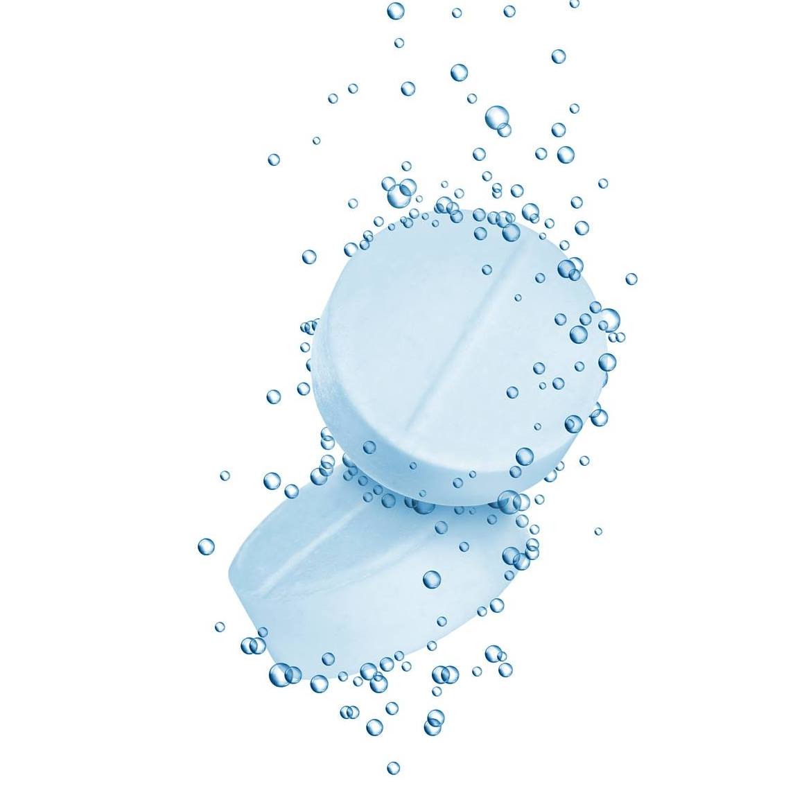 Close-up of two water purification tablets dissolving with bubbles, illustrating chemical water treatment for waterborne illness prevention.